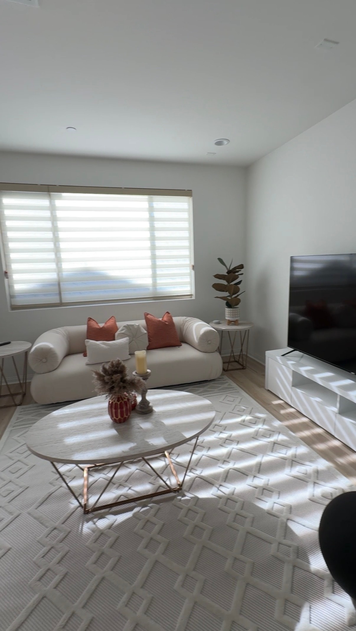 Airbnb living room with curved sofa and TV
